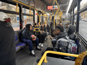 A group of people riding an MTA bus